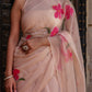 Beige floral chiffon saree with pink floral print and elegant draping for festive occasions