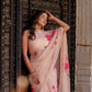 Elegant beige floral chiffon saree draped beautifully with pink flower patterns, perfect for festive occasions.