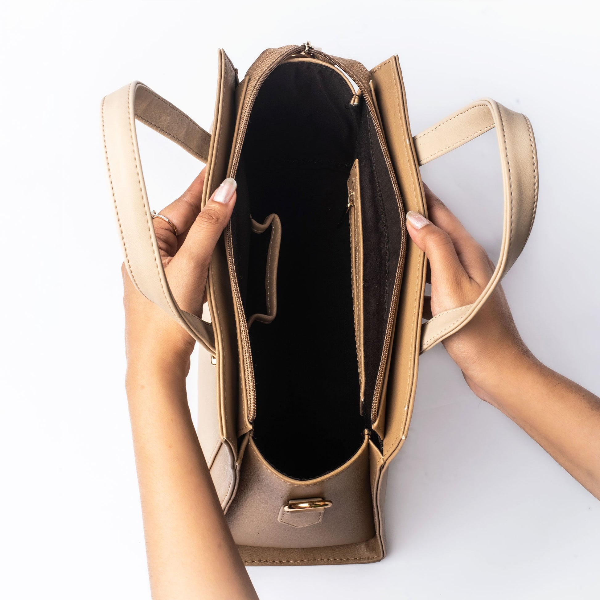 Interior view of a beige luxury handbag for women showcasing spacious compartments and elegant design