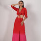 Stylera beach wear model wearing a stylish ombre skirt and top set red to pink tie front crop top with high slit skirt