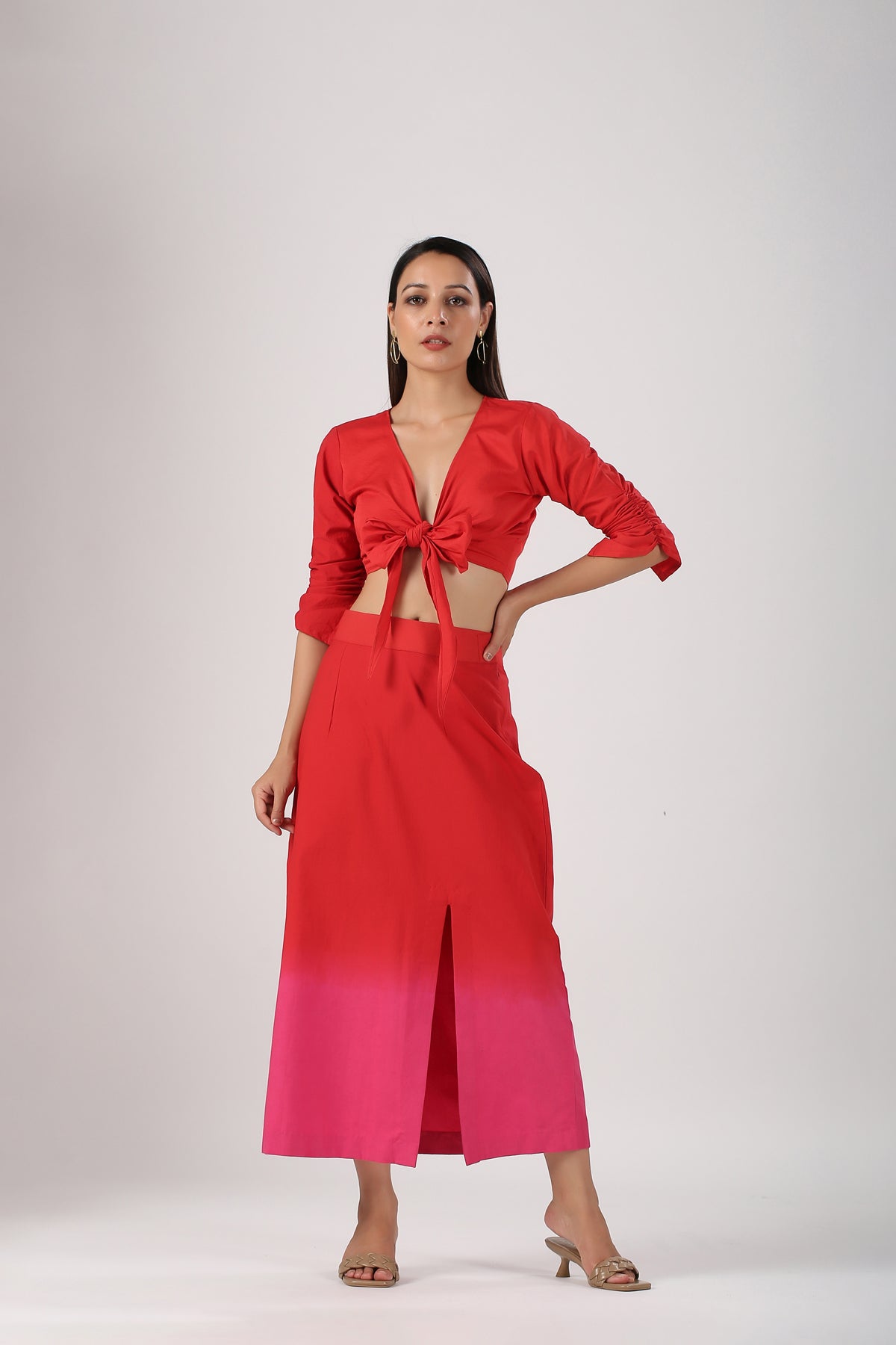 Model wearing Stylera beach wear stylish ombre skirt and top set red to pink front tie crop top with slit