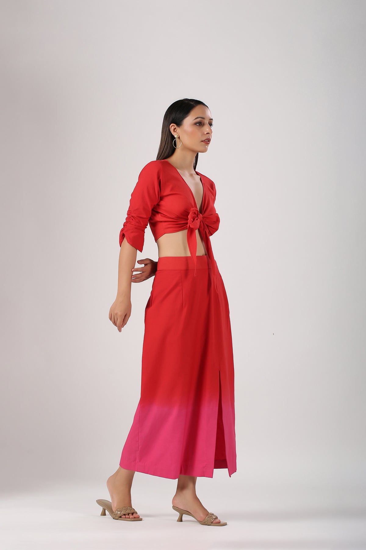 Model wearing Stylera beach wear stylish ombre skirt and top set in red to pink gradient with front slit and tie top