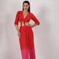Stylera beach wear model in a stylish ombre skirt and top set red to pink tie front crop top and slit maxi skirt