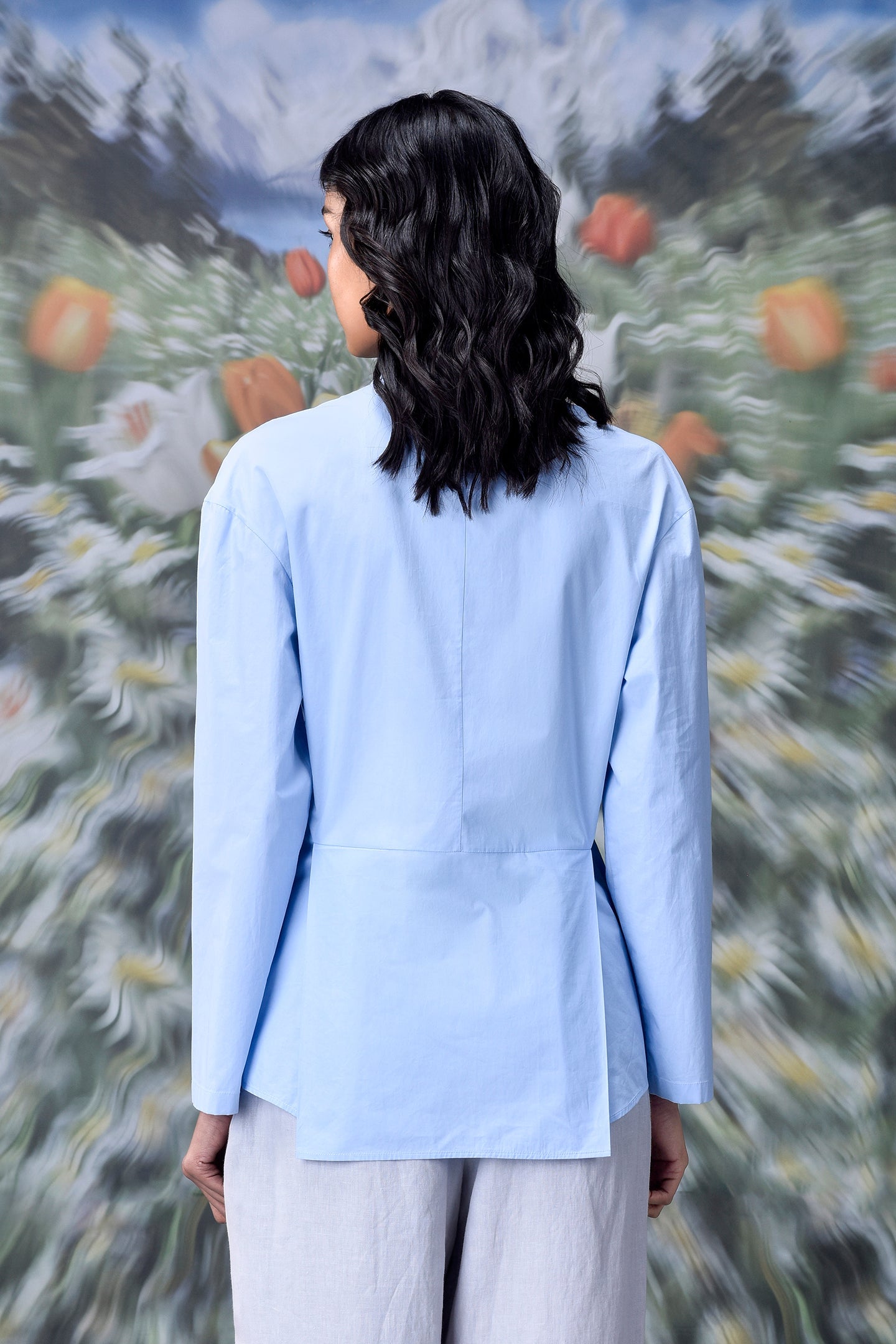 Back view of model wearing unique casual light blue shirt for women by Stylera long sleeves