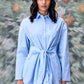 Stylera model wearing unique casual light blue shirt for women with tie waist and long sleeves