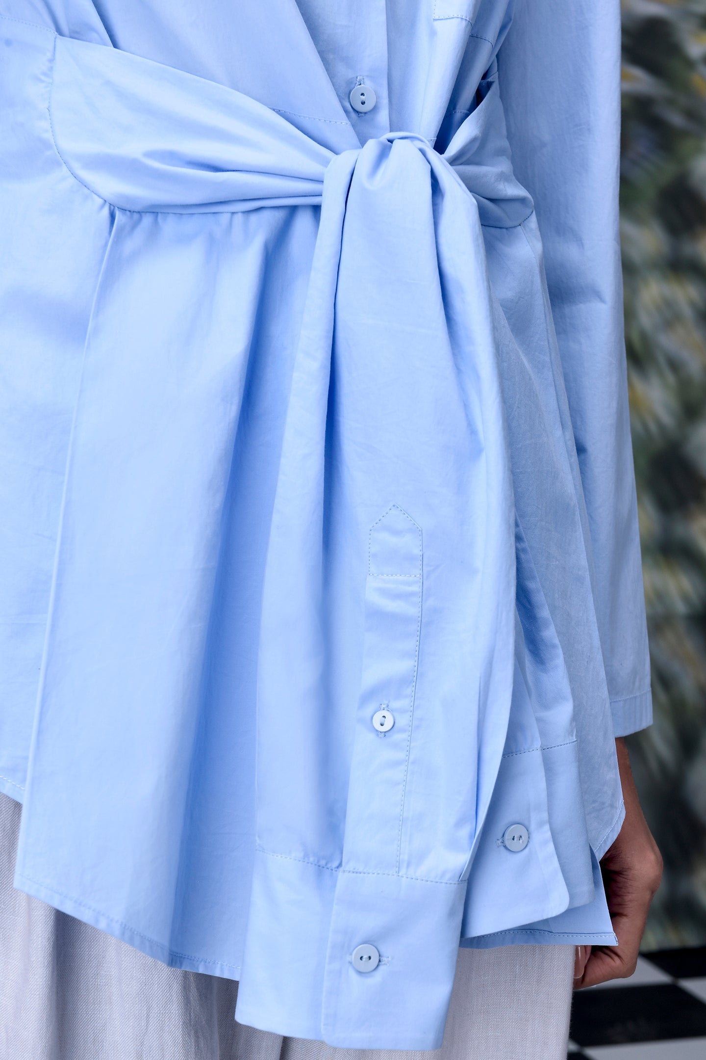 Stylera unique casual light blue shirt for women with waist tie and button cuffs close up
