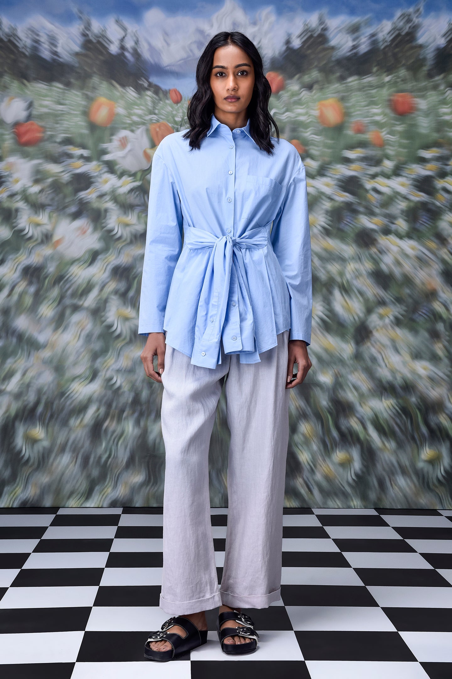 Stylera model wearing unique casual light blue shirt for women tie front long sleeves with wide leg pants
