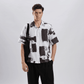 Stylera black and white artsy shirt for men shown on male model wearing short sleeve brushstroke print shirt with black tote