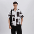 Stylera black and white artsy shirt for men shown on male model wearing short sleeve brushstroke print shirt with black tote