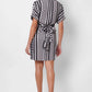 Stylera black and white wrap dress with short sleeves and tie waist, back view on model
