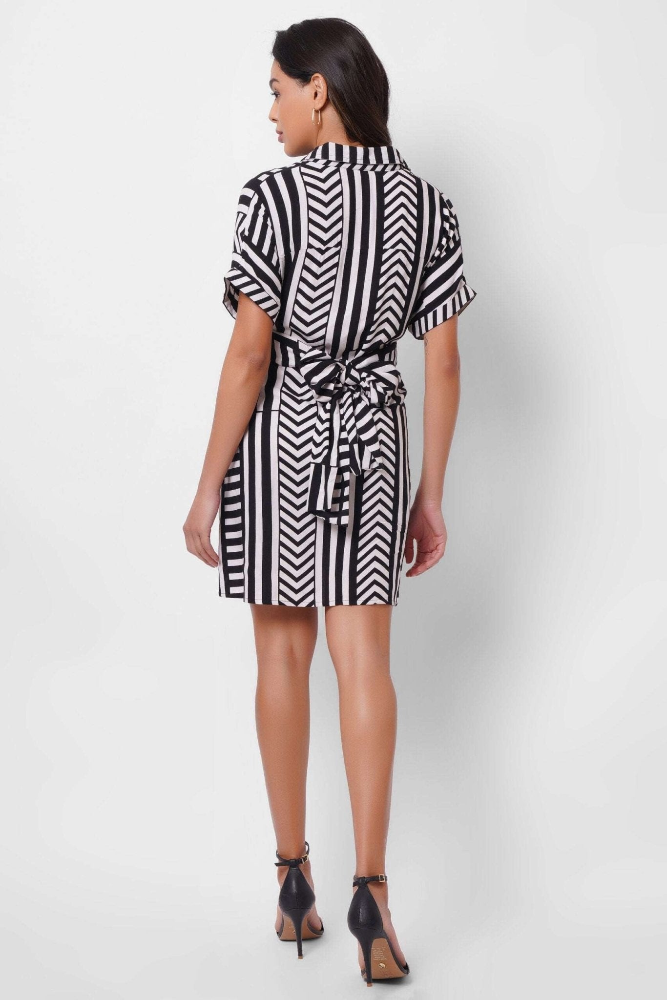 Stylera black and white wrap dress with short sleeves and tie waist, back view on model