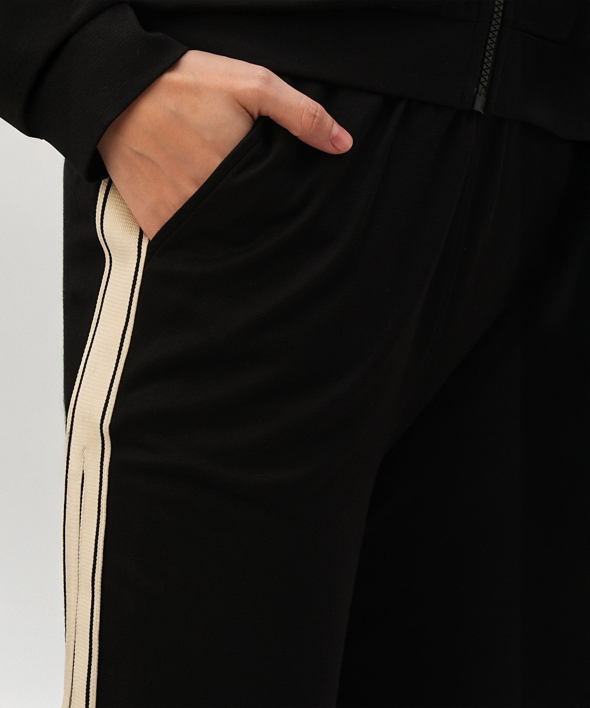 Close-up of a black co-ord set for women featuring stylish side stripes and convenient pockets