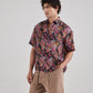 Black floral drop shoulder shirt from Stylera featuring vibrant tropical prints