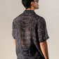Back view of a black geometric silk shirt for men featuring a stylish pattern from Stylera