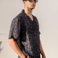 Black geometric silk shirt for men by Stylera, featuring a stylish design and relaxed fit