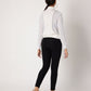 Model wearing black high waisted metallic leggings paired with a white top from Stylera