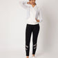 Black high waisted metallic leggings paired with a stylish white zip-up jacket for a sporty look