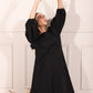Elegant black midi dress for women with voluminous sleeves, perfect for stylish occasions