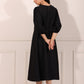 Elegant black midi dress for women with balloon sleeves and a relaxed fit, perfect for casual outings