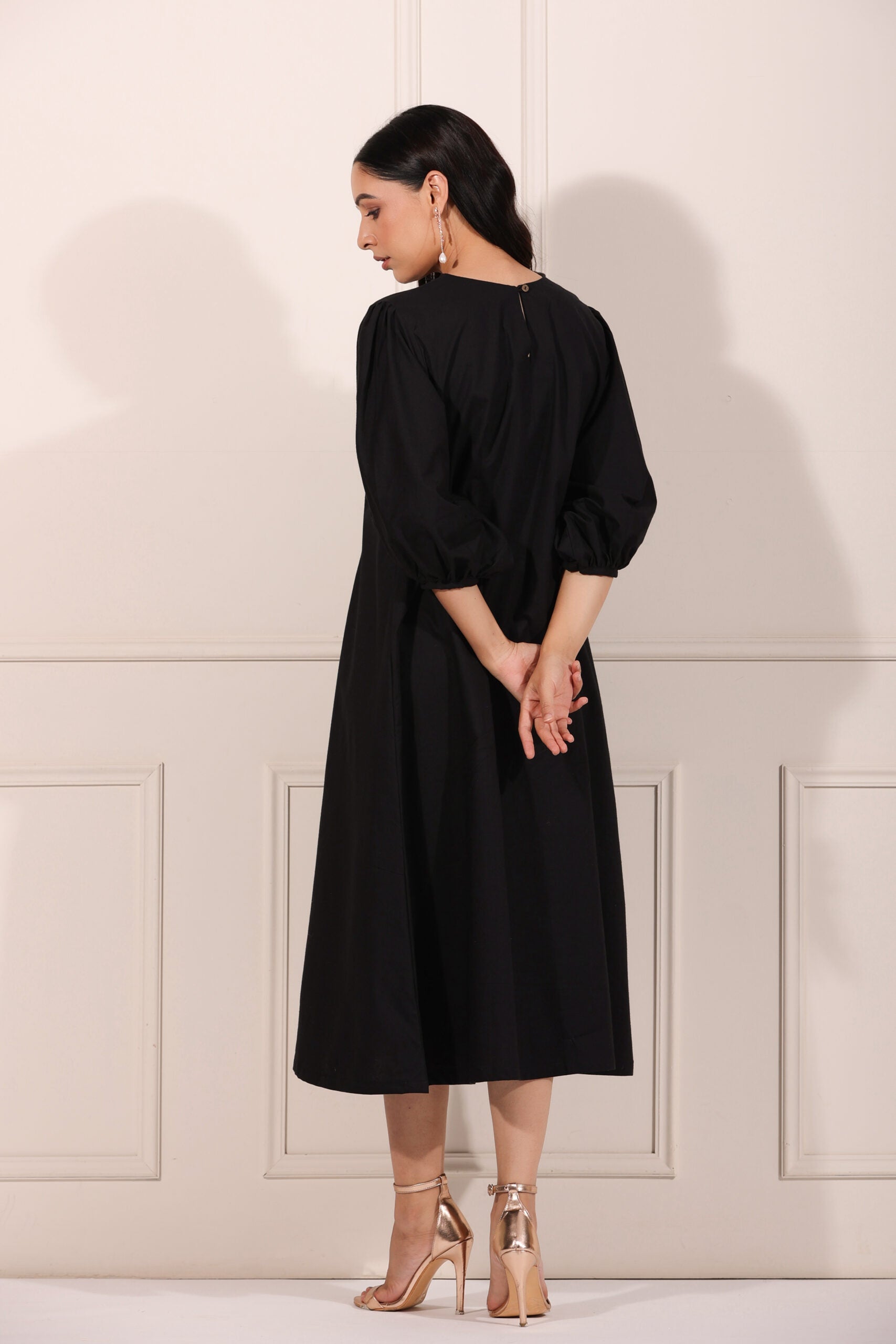 Elegant black midi dress for women with balloon sleeves and a relaxed fit, perfect for casual outings