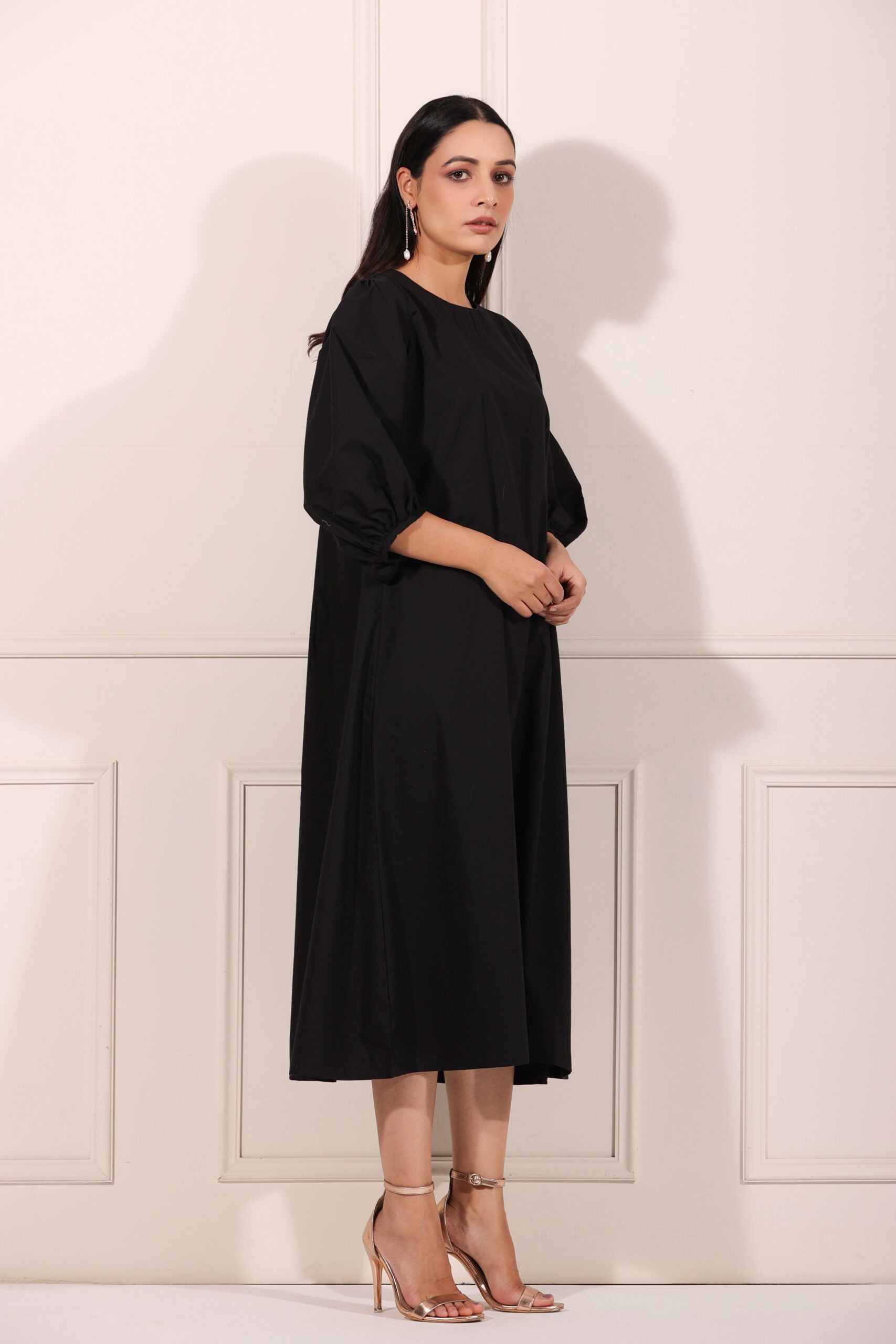 Elegant black midi dress for women with puff sleeves and a flowy silhouette