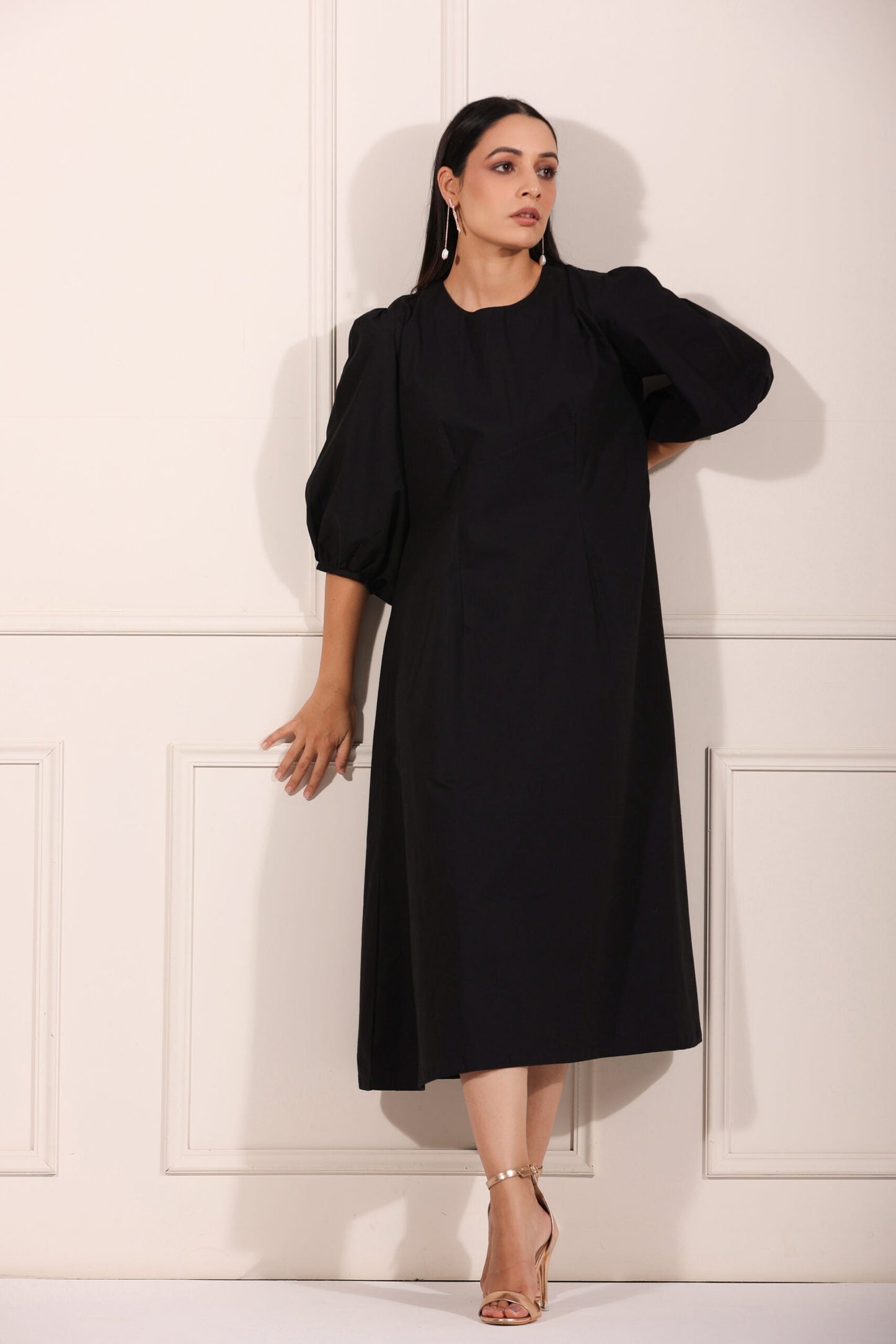 Elegant black midi dress for women with puff sleeves, perfect for casual or formal occasions