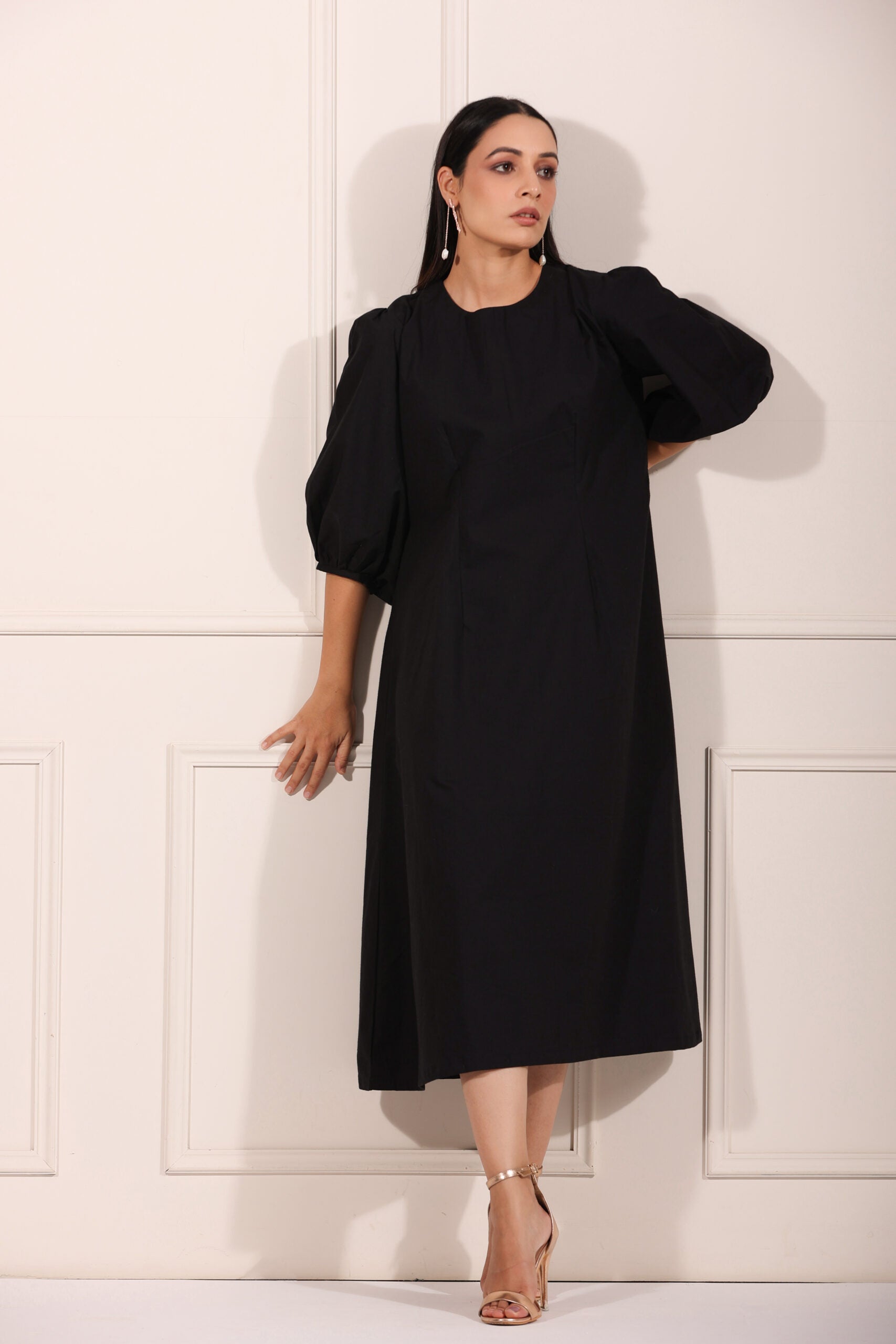 Elegant black midi dress for women with puff sleeves, perfect for casual or formal occasions