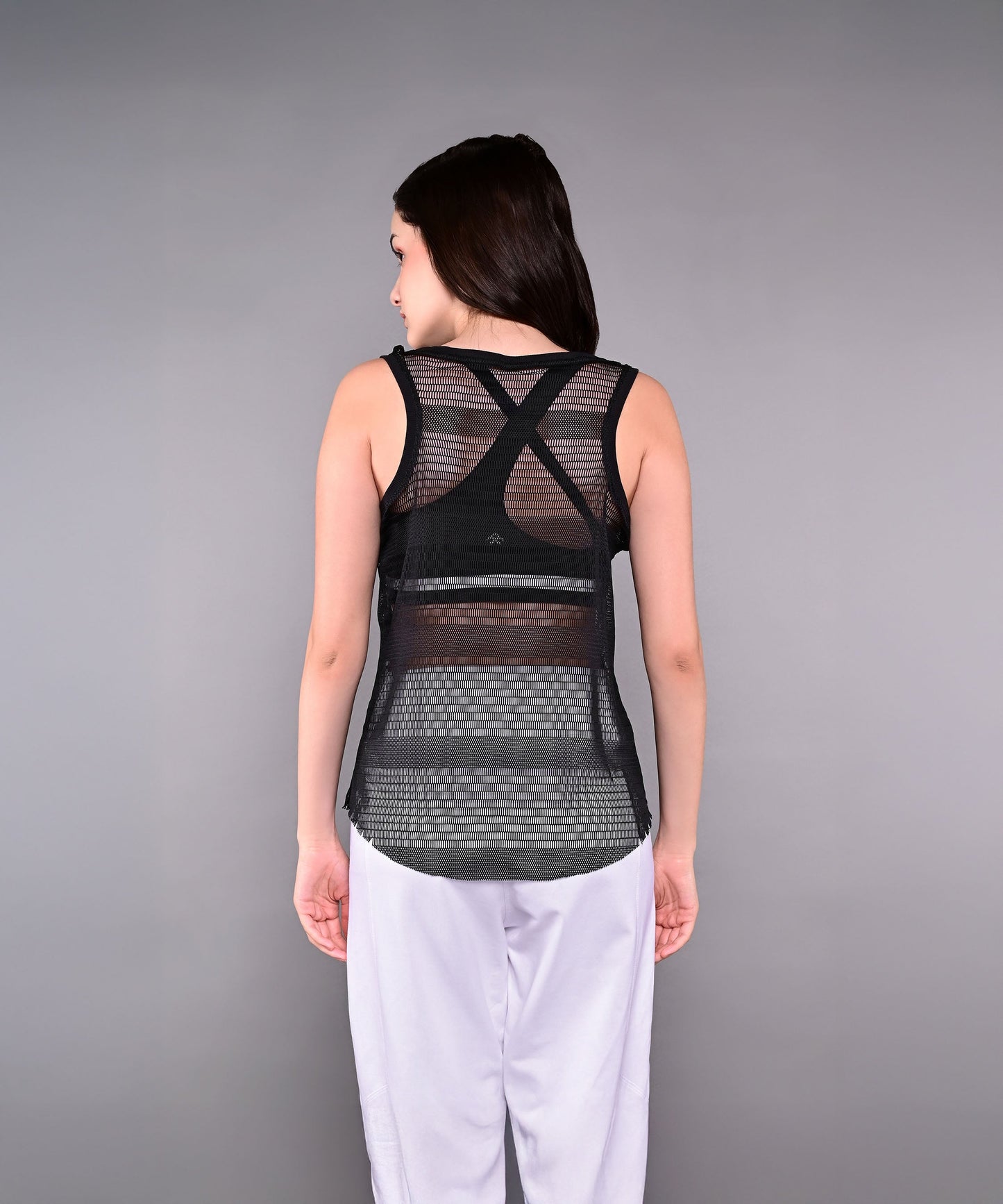 Back view of black netted tank top for women with stylish crisscross design and breathable fabric