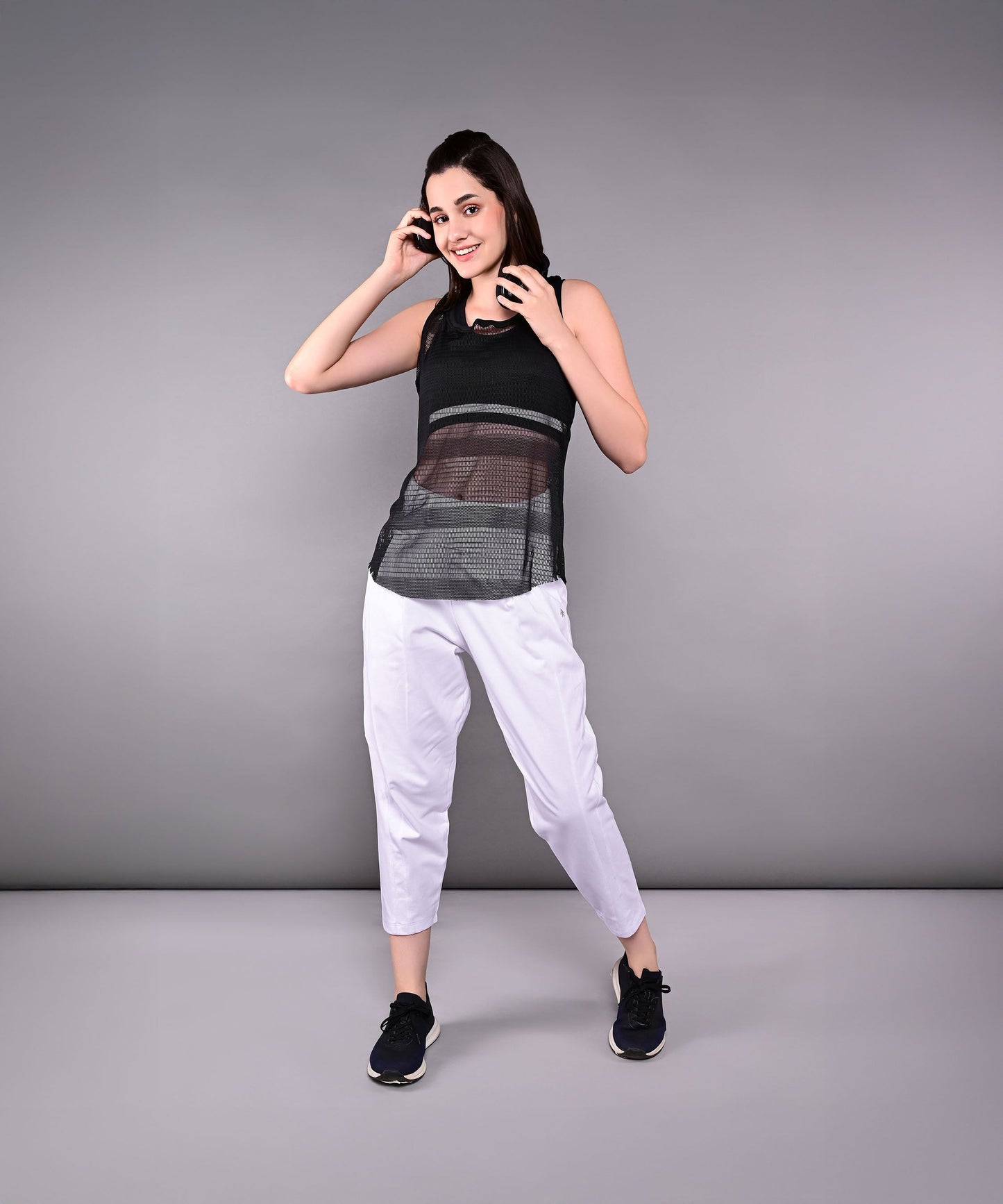 Stylish black netted tank top for women, perfect for workouts and casual wear.