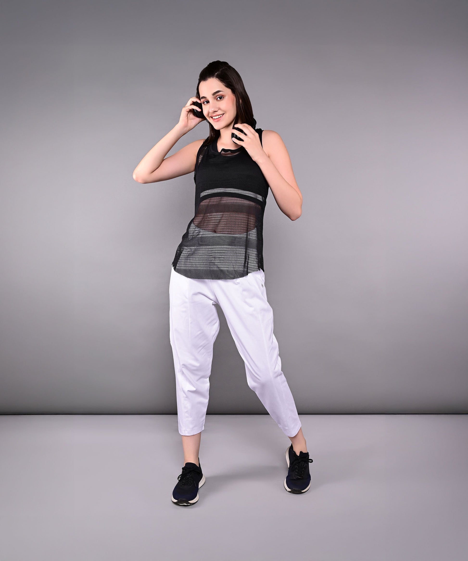 Stylish black netted tank top for women, perfect for workouts and casual wear.
