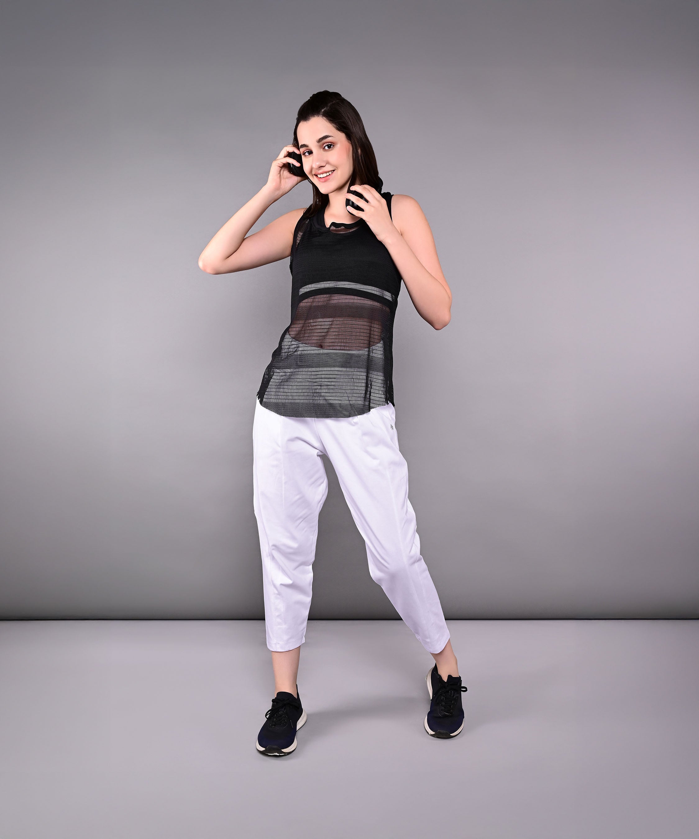 Stylish black netted tank top for women, perfect for workouts and casual wear.