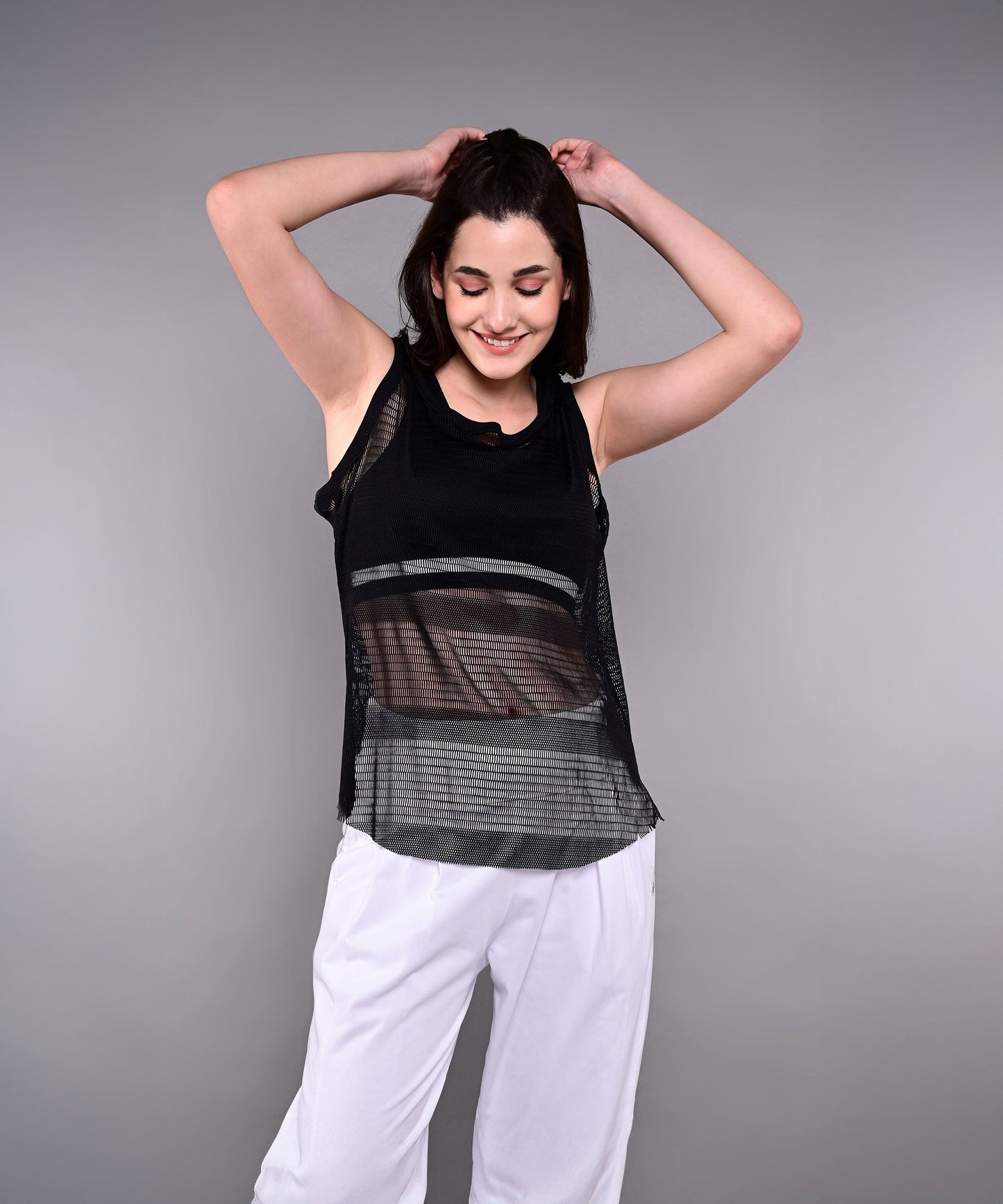 Stylish black netted tank top for women with a breathable design, perfect for workouts and casual wear