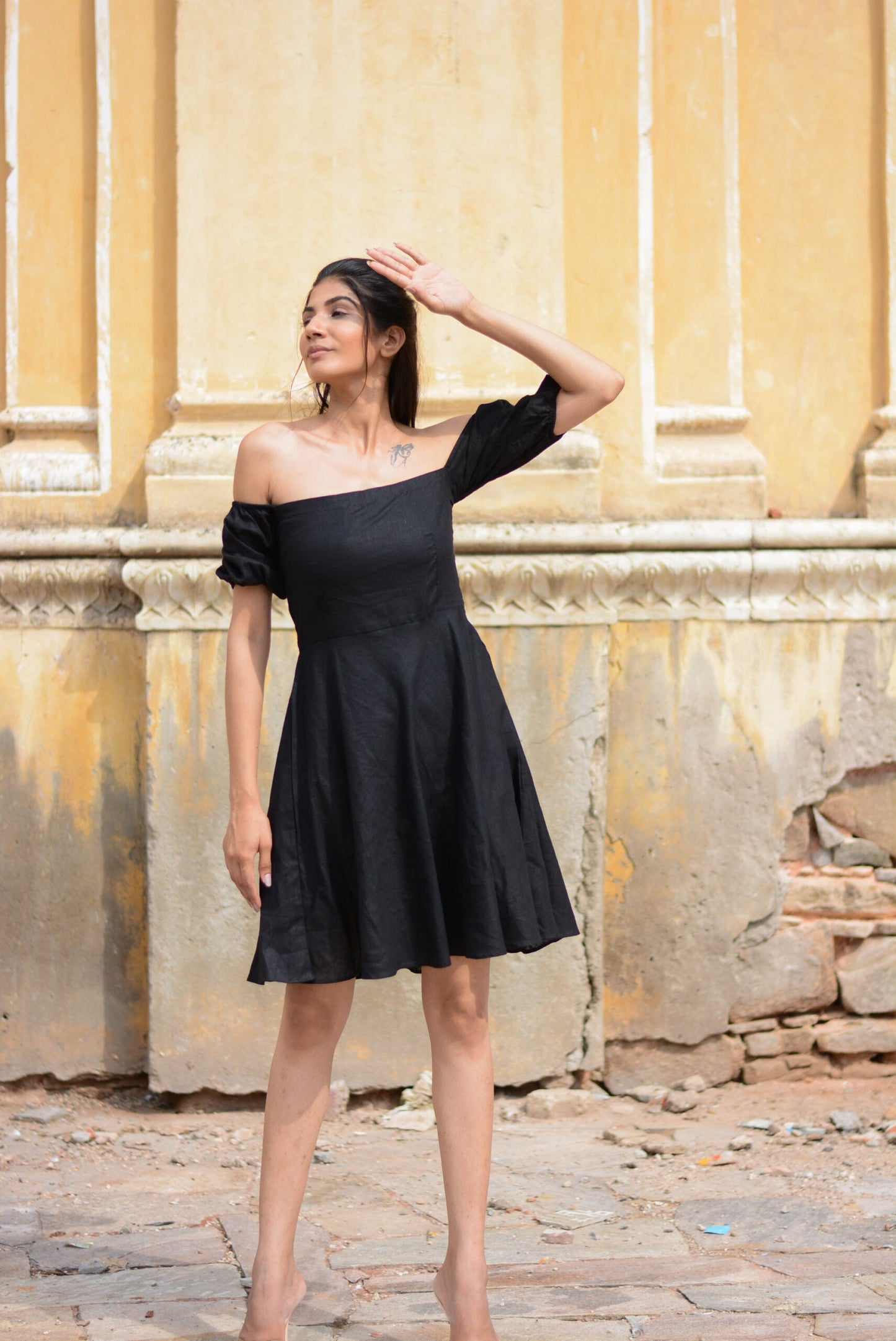 Elegant black off shoulder short dress with puff sleeves, perfect for casual outings or summer events