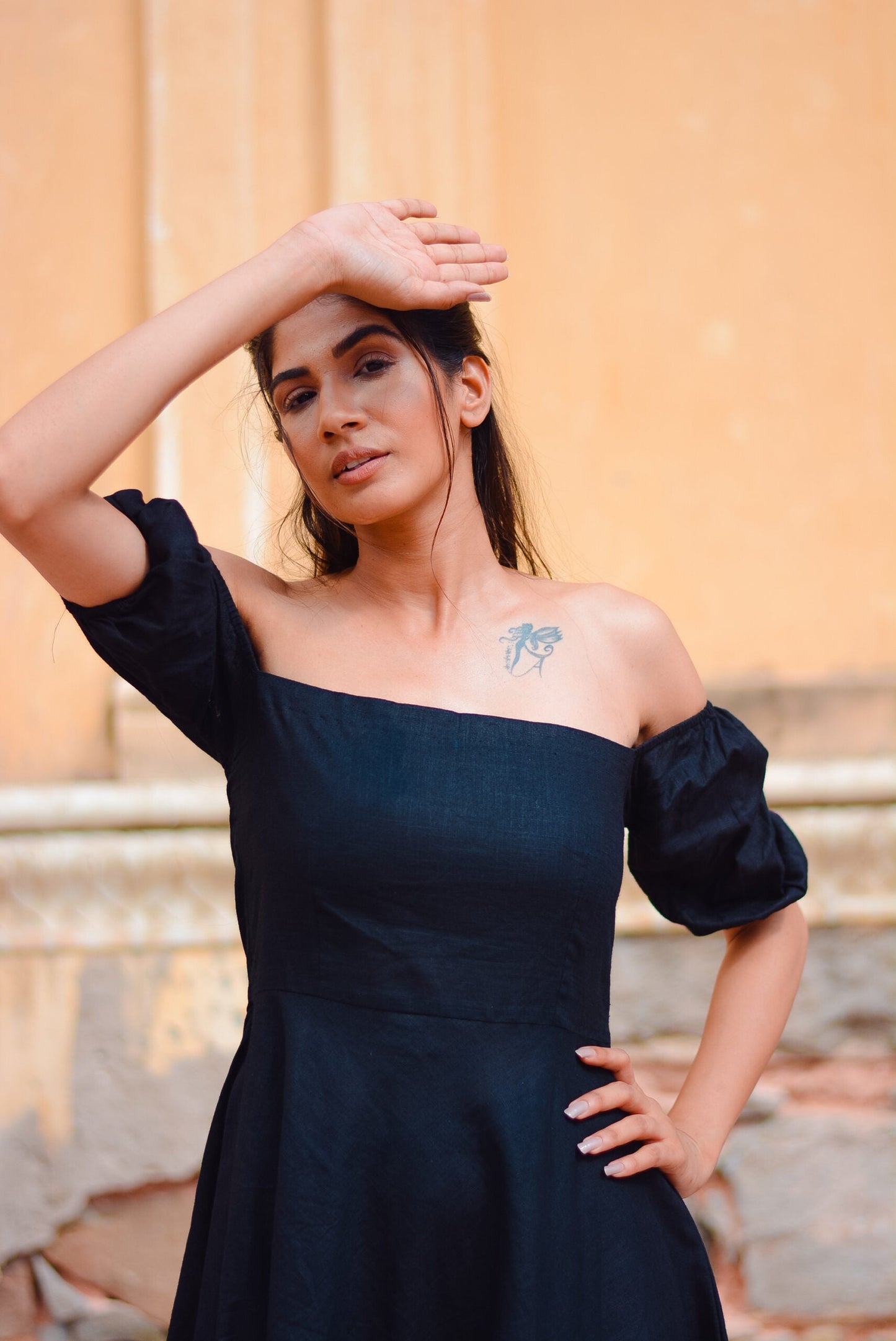 Elegant black off shoulder short dress featuring puff sleeves and a fitted bodice
