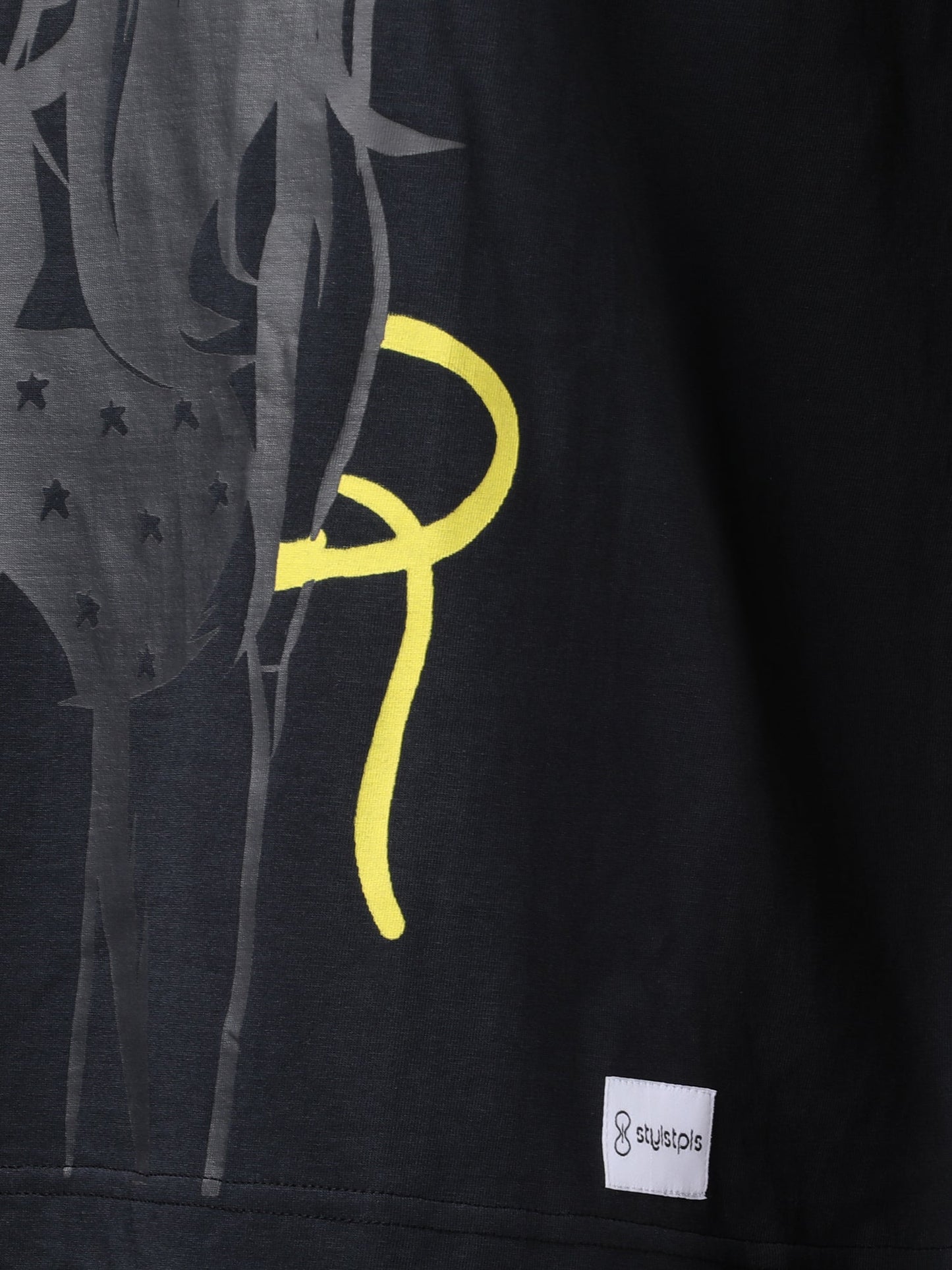 Stylstpls black oversized crew neck t-shirt featuring a unique graphic design on the front