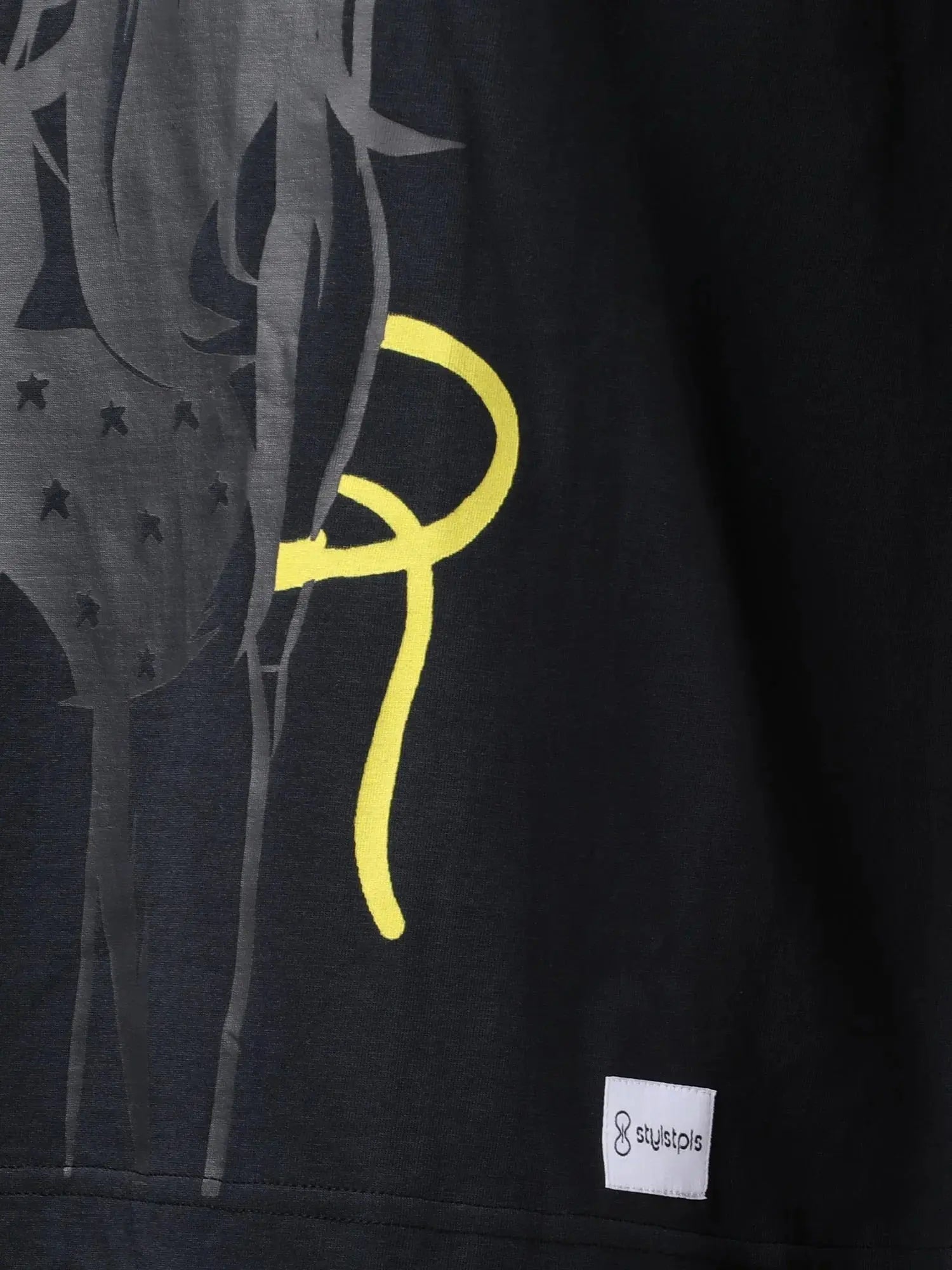 Stylstpls black oversized crew neck t-shirt featuring a unique graphic design on the front