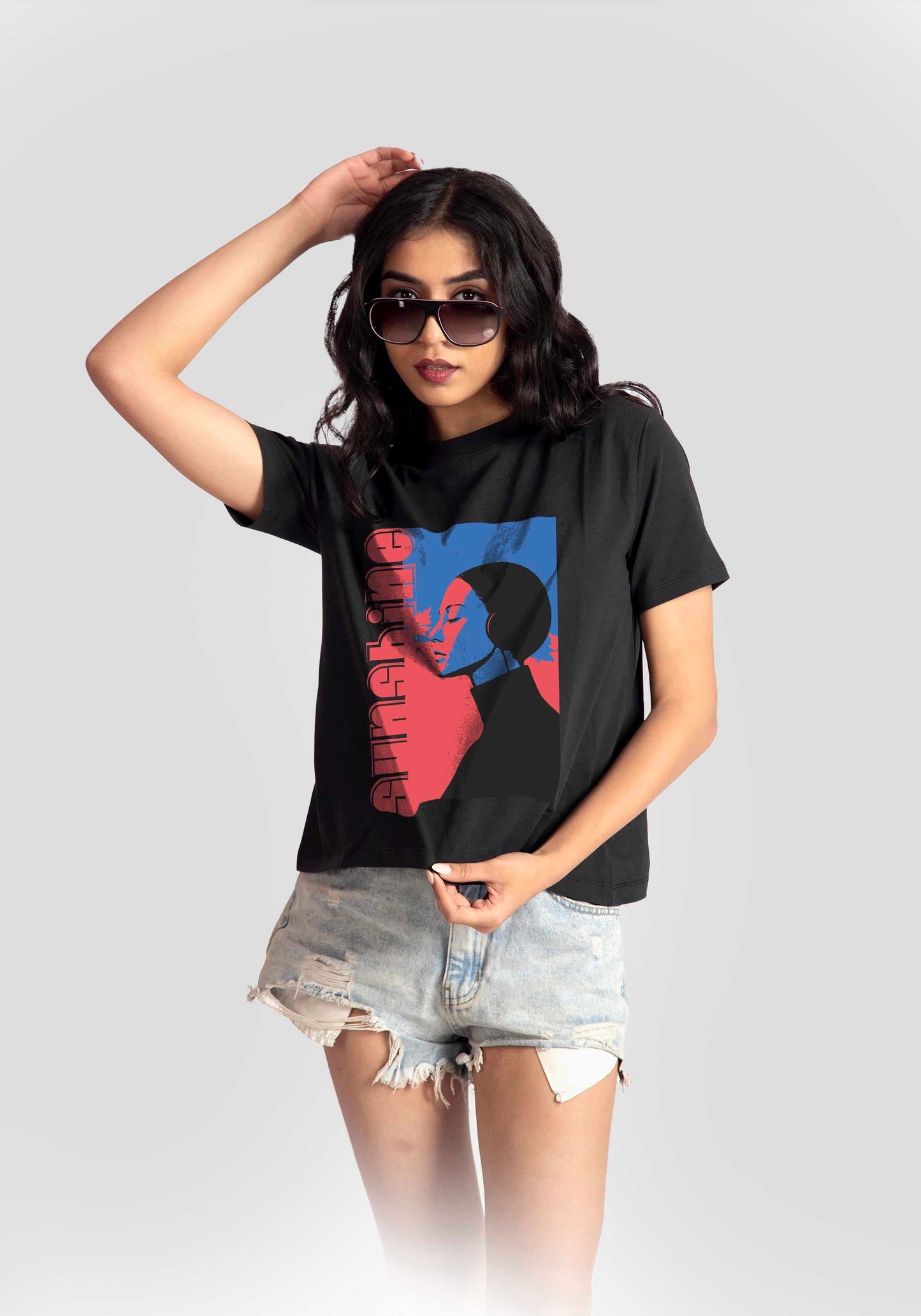 Stylera black print t-shirt for women featuring colorful graphic worn with denim shorts