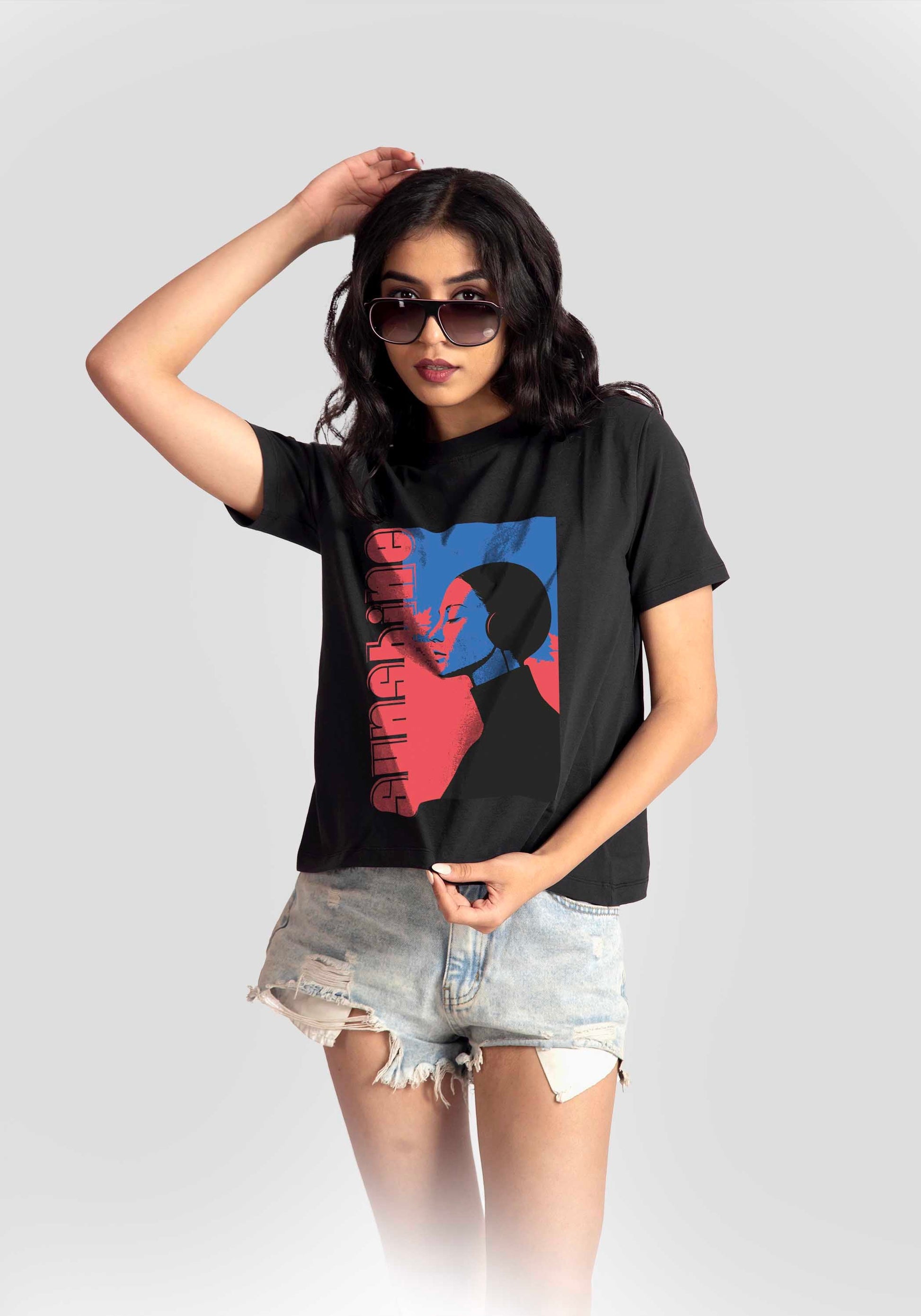 Stylera black print t-shirt for women featuring colorful graphic worn with denim shorts