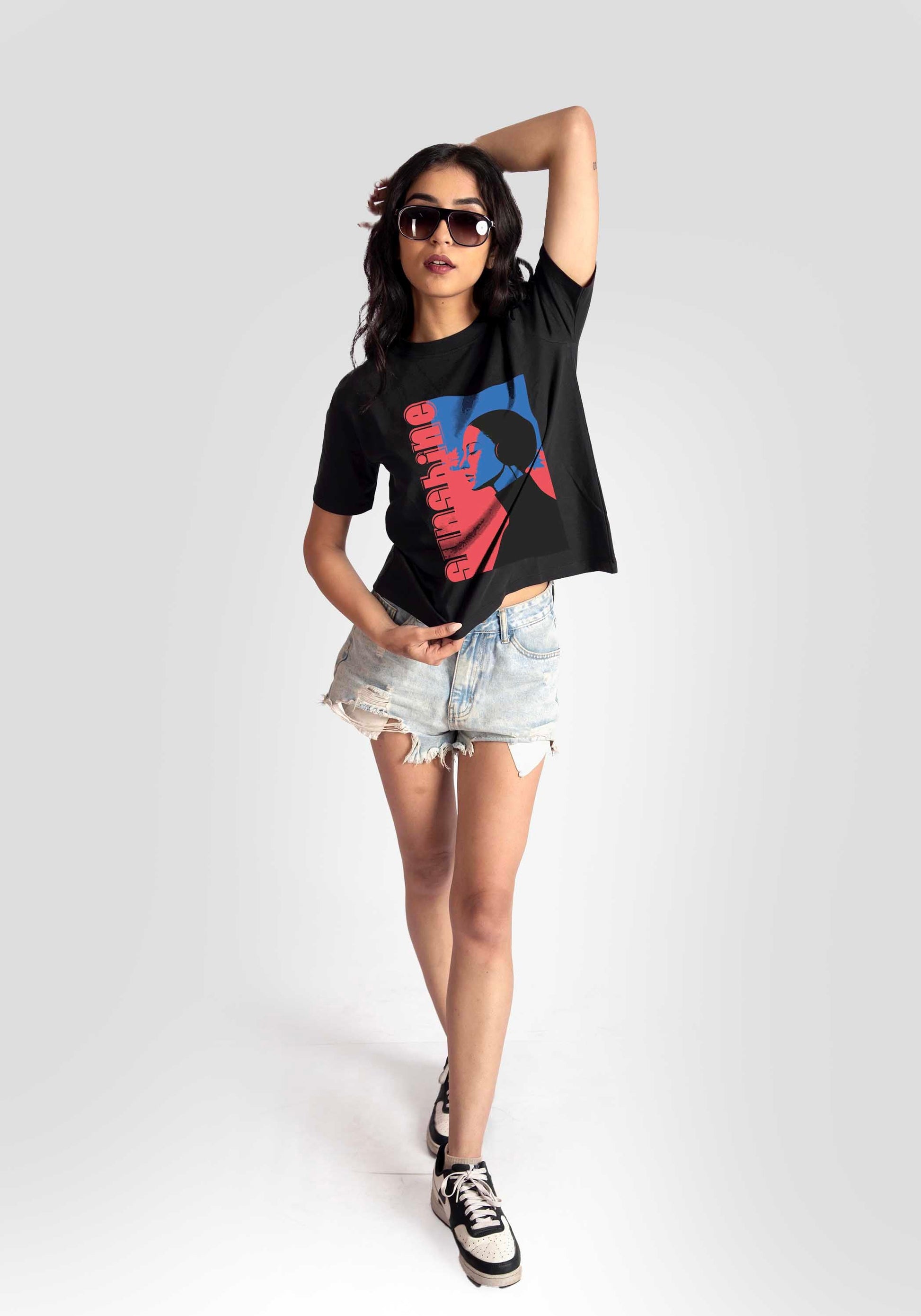 Black print t-shirt for women by Stylera with graphic worn with denim shorts and sunglasses