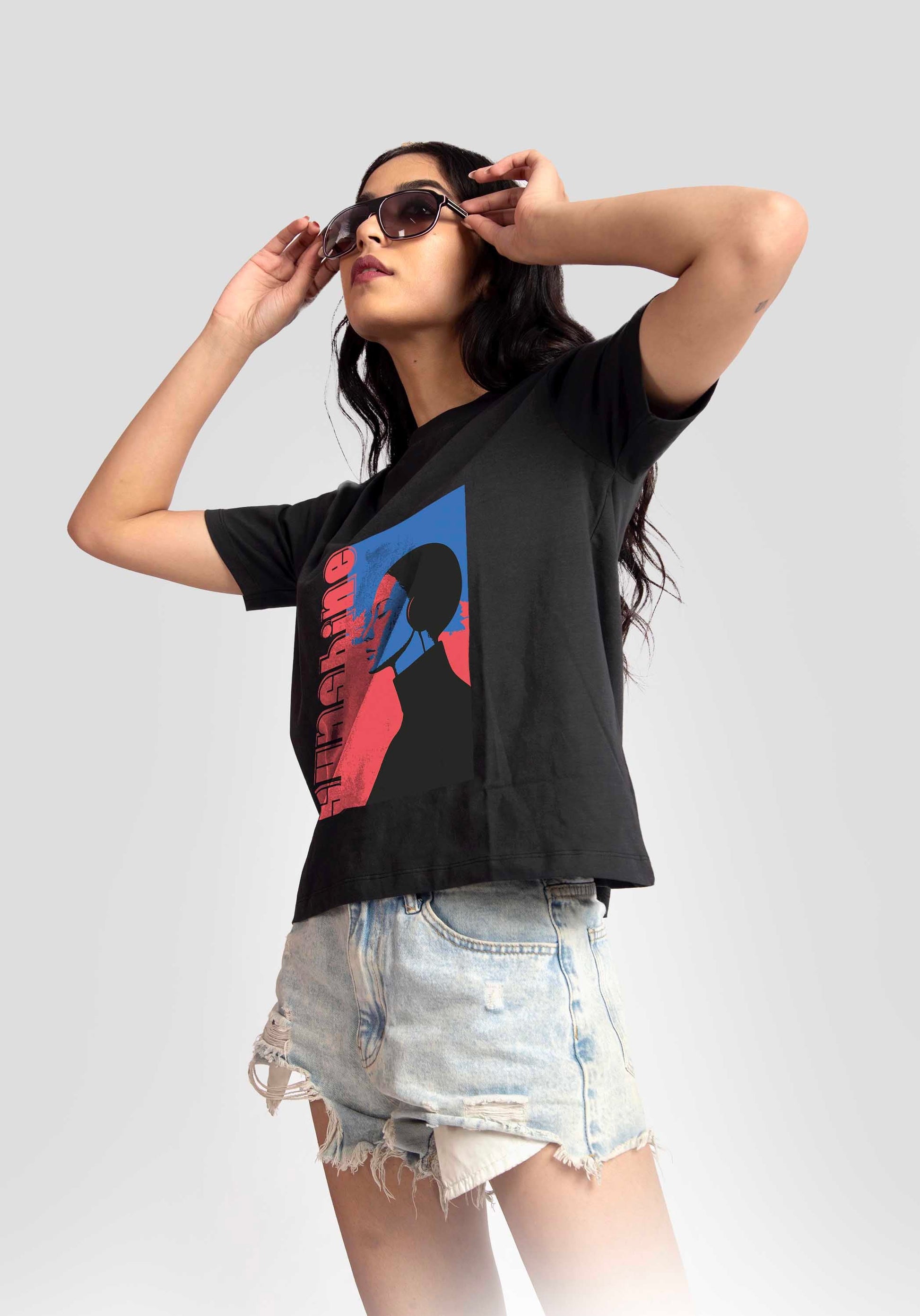 Stylera black print t-shirt for women featuring graphic worn with denim shorts