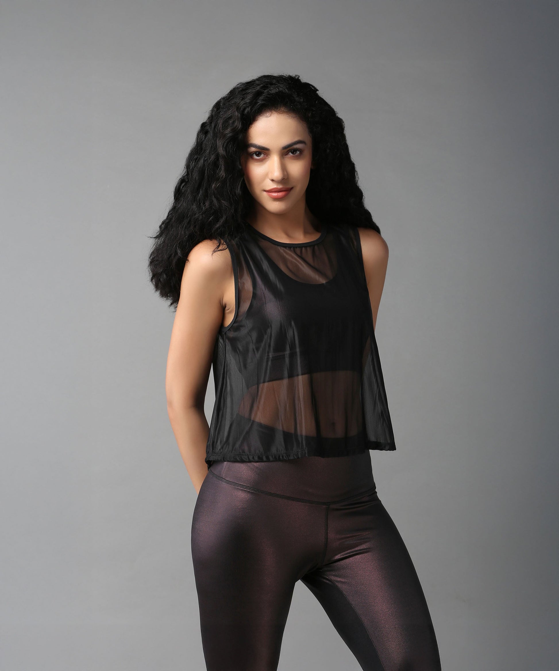 Stylish black sheer top for women, perfect for layering over activewear or casual outfits.