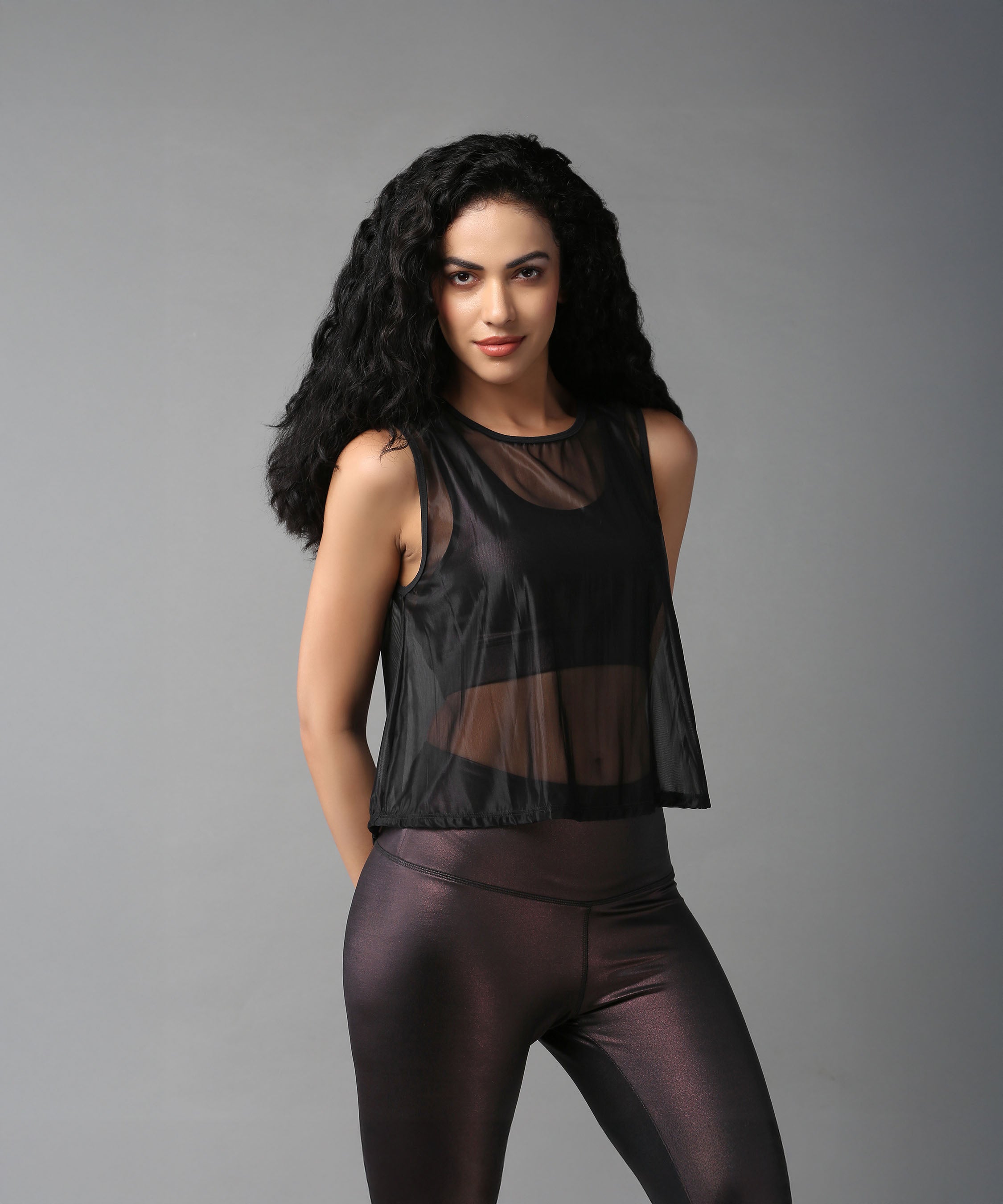 Stylish black sheer top for women, perfect for layering over activewear or casual outfits.