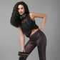 Stylish black sheer top for women paired with shiny leggings and headphones for an active look