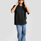 Woman wearing black streetwear oversized tee womens with blue jeans and sunglasses by Stylera