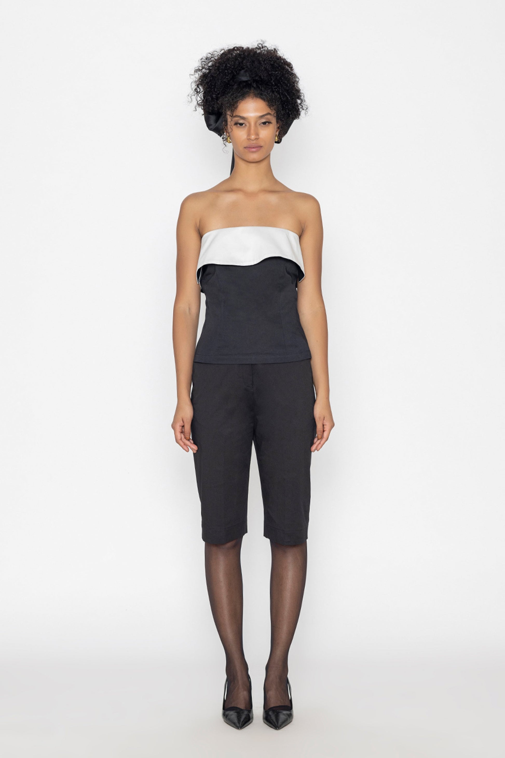 Stylera black swan inspired fashion top with strapless white and black design worn with black pants