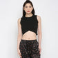 Stylera black twisted crop top featuring a stylish knotted front and sleeveless design