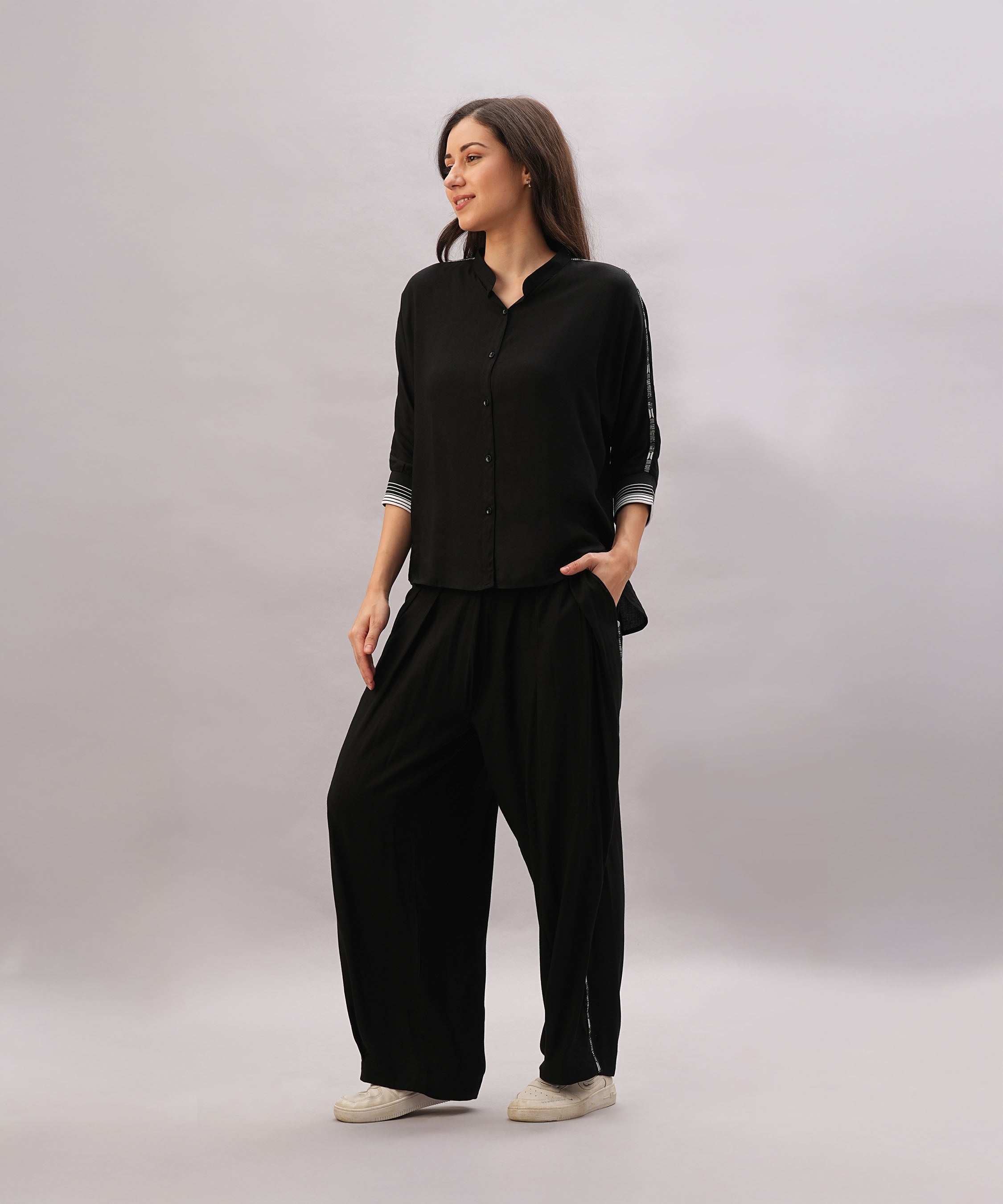 Stylish black two piece lounge set women featuring a button-up top and loose-fitting pants