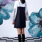 Back view of Stylera black white layered dress with embroidered white sleeves knee socks and platform sneakers