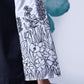 Stylera black white layered dress close up of embroidered white sleeve and black dress body on check floor