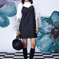 Stylera model wearing black white layered dress over printed bell sleeve tee with knee socks and sneakers